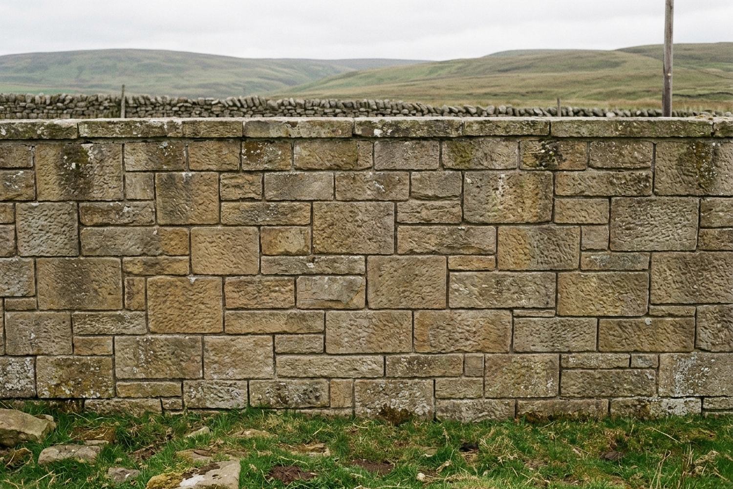 Coursed stone blocks of clearly different sizes in a wall, seen square on.
